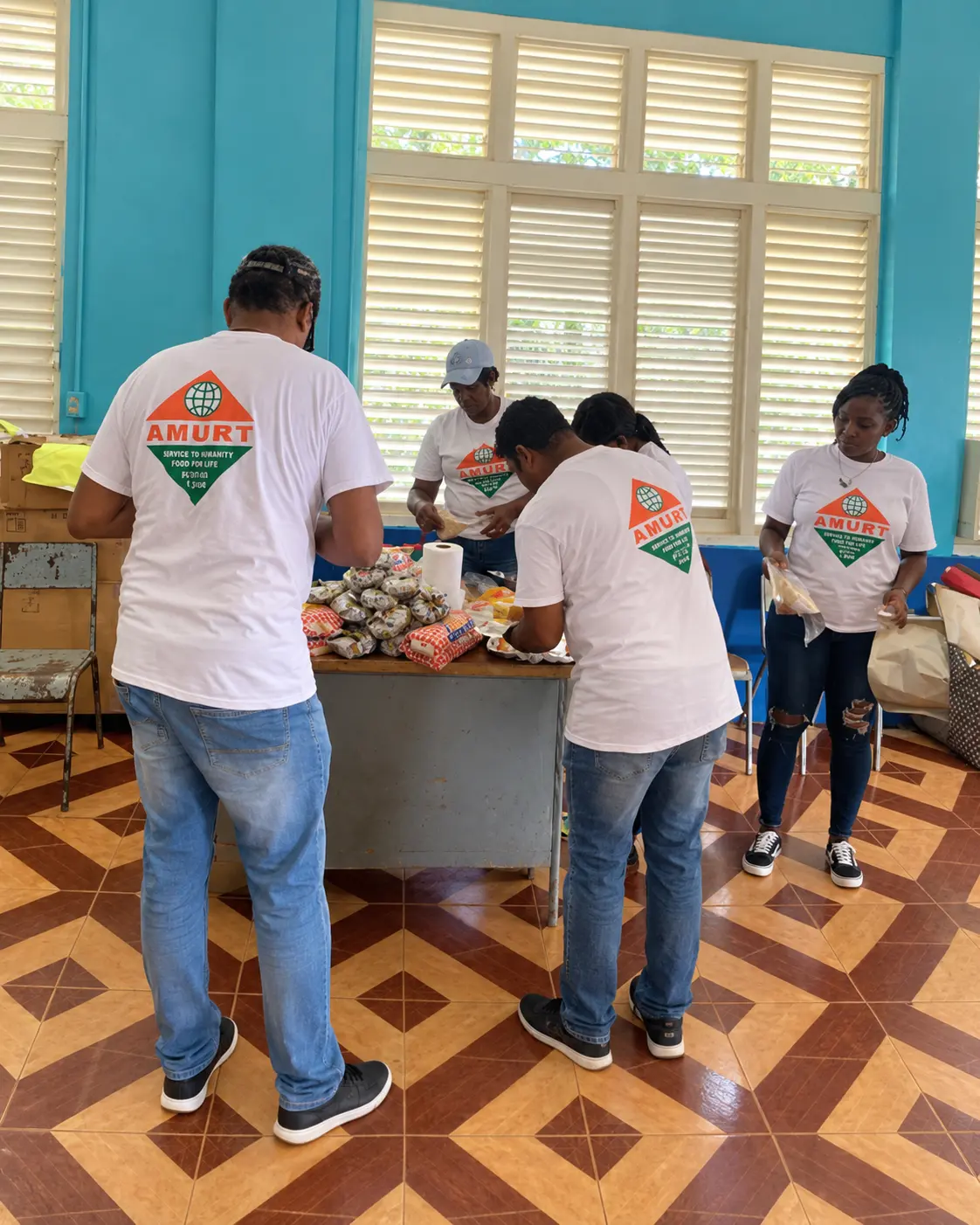 AMURT Jamaica volunteers preparing food and relief supplies